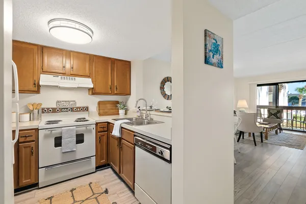 a kitchen with a stove top oven sink and cabinets