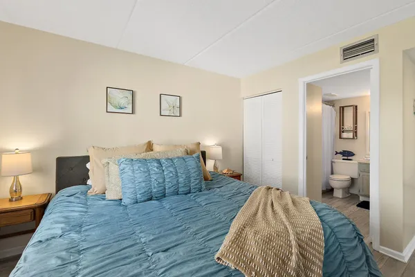 a bedroom with a bed and wooden floor