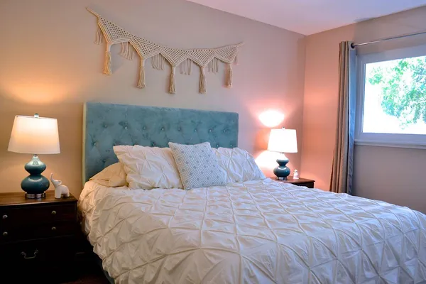a bedroom with a bed and a lamp