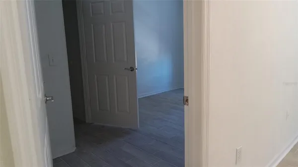 a view of a hallway with wooden floor