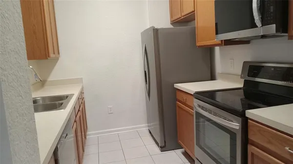 a kitchen with stainless steel appliances granite countertop a refrigerator and a stove