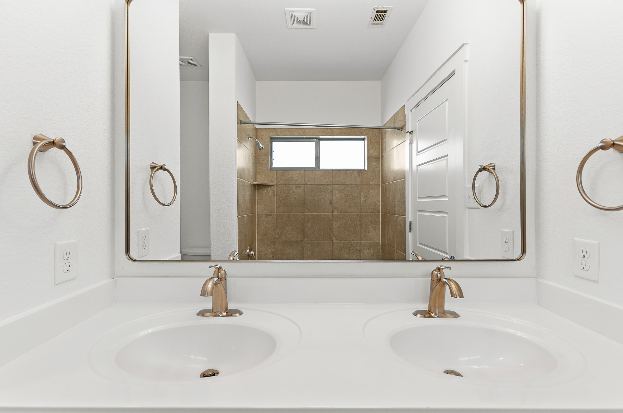 2101 Rivers Edge Way, Unit 25 Austin, TX 78741 - Photo 9 of 20 A classic double vanity with bronze fixtures integrates seamlessly into the clean bathroom layout.