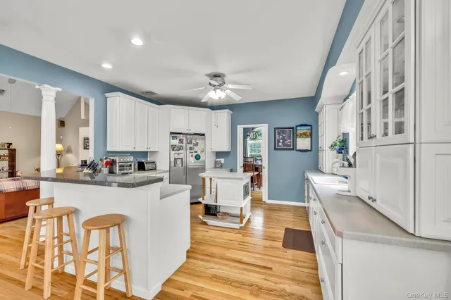 a kitchen with white cabinets and appliances