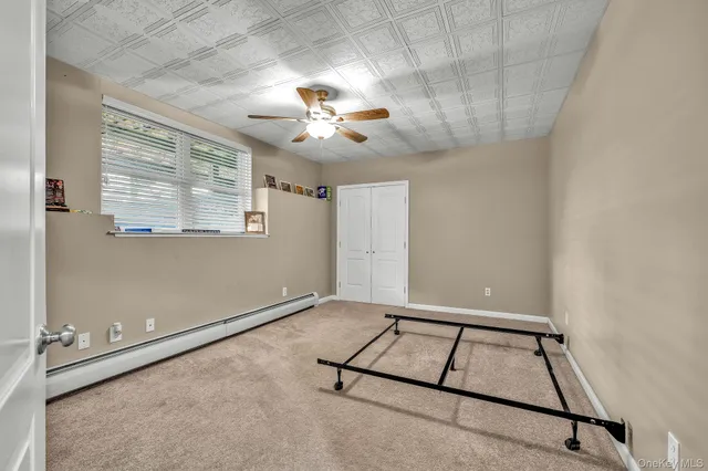 a view of a room with window and ceiling fan