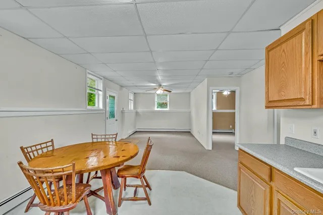 a dining room with furniture and window