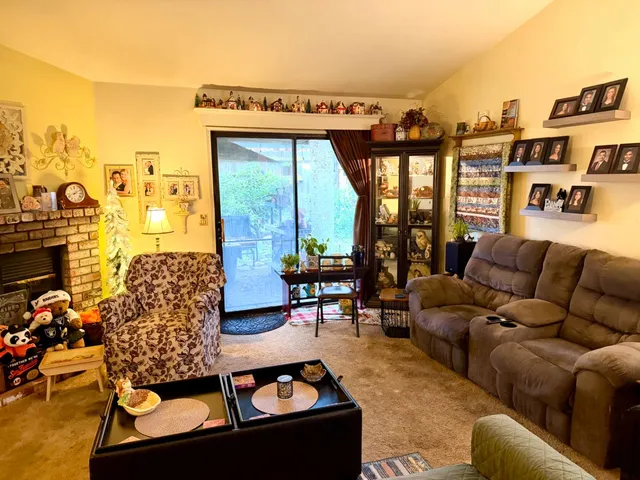 a living room with furniture and a floor to ceiling window