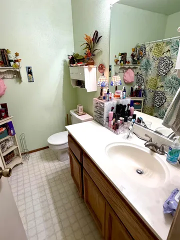 a bathroom with a sink toilet and mirror