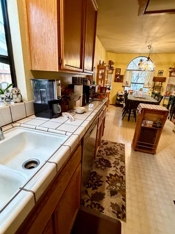 a kitchen with a sink and a stove top oven