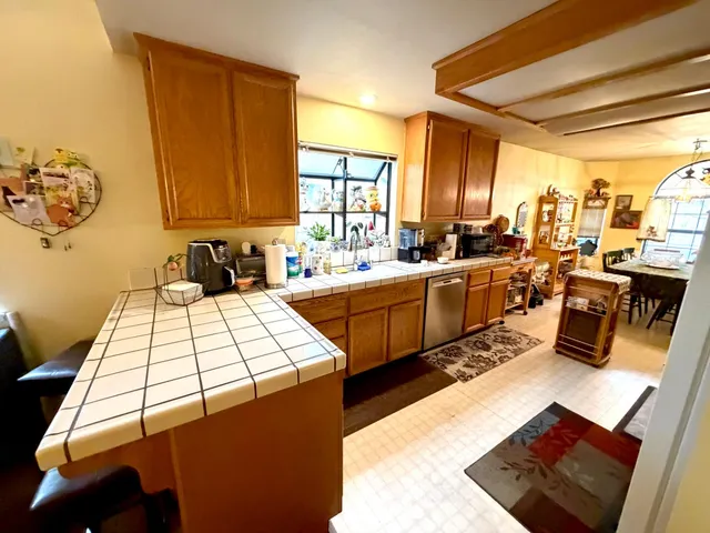 a kitchen with a sink appliances and cabinets