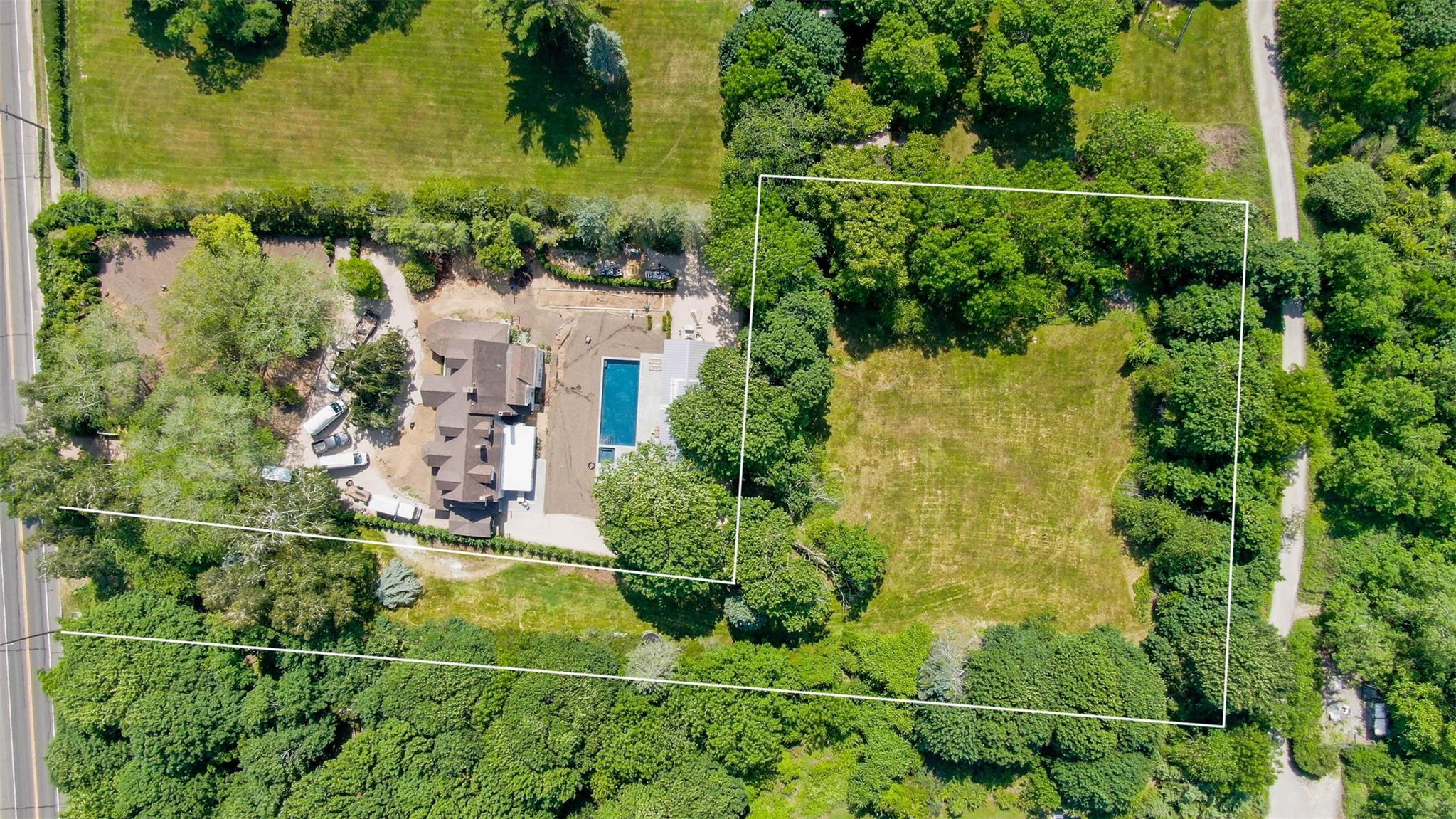 2365 Main Road Greenport, NY 11944 - Photo 2 of 4 an aerial view of a residential houses with outdoor space and trees all around