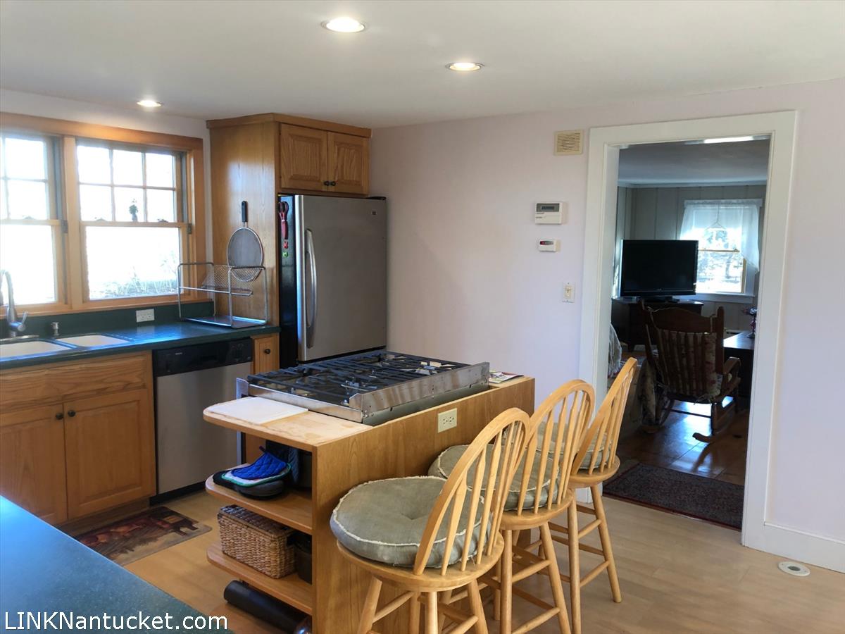 8 M Street Nantucket, MA 02554 - Photo 7 of 20 a kitchen with a stove a sink and a refrigerator
