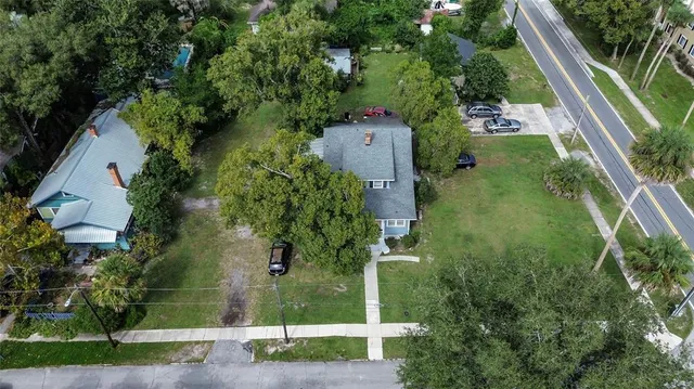 an aerial view of a house with a yard