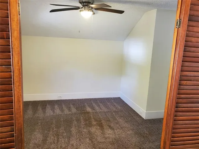 a living room with furniture a rug and white walls
