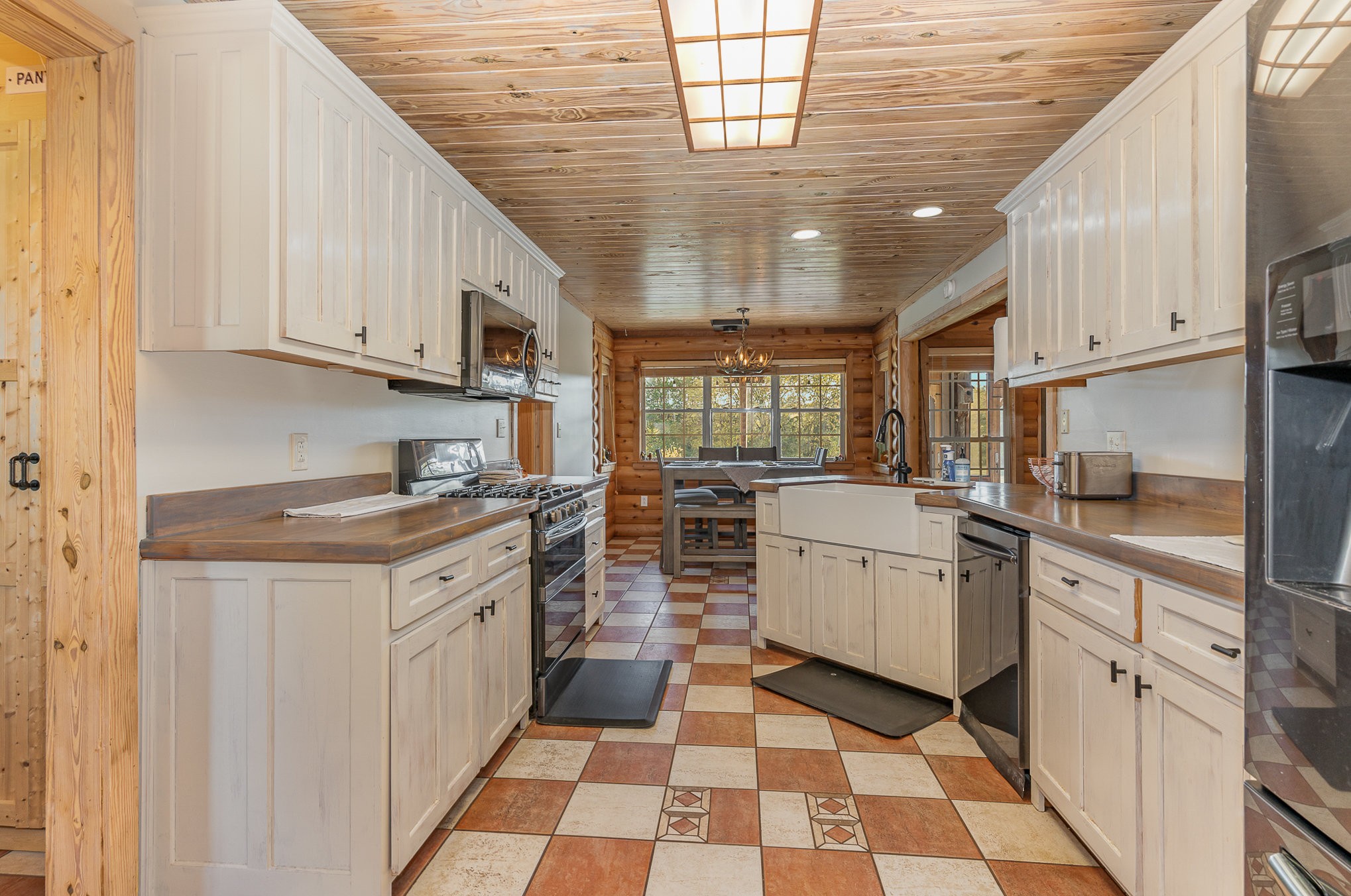 2065 Patterson Cemetery Road Chapel Hill, TN 37034 - Photo 16 of 39 a kitchen with a sink dishwasher stove and white cabinets with wooden floor