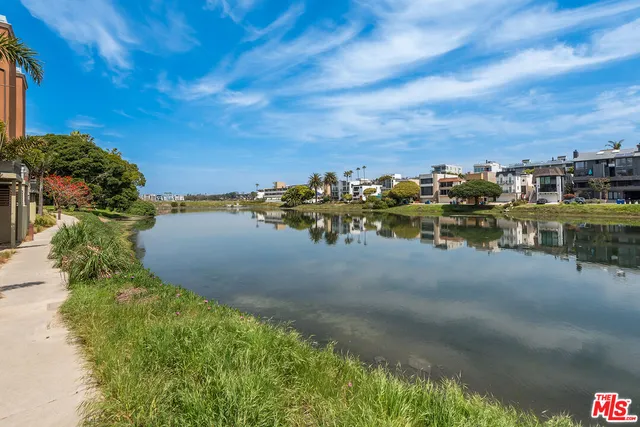 a view of a lake with houses in the back