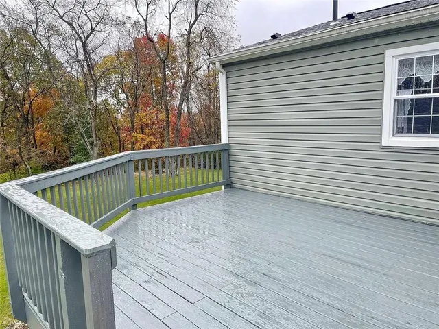 a view of a balcony with wooden floor