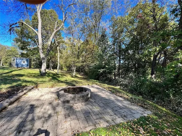 a view of a backyard with large trees