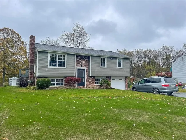 a view of a house with a yard and sitting area
