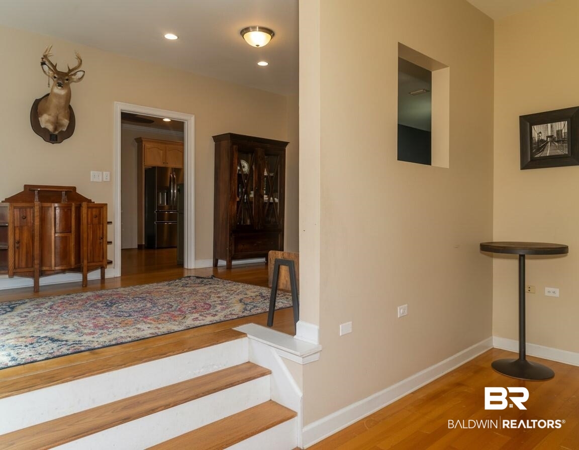 8008 Patricks Landing Road Bay Minette, AL 36507 - Photo 9 of 33 Rich hardwood flooring extends from the entryway steps throughout the space