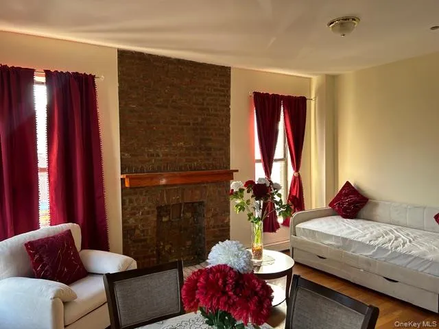 a living room with furniture and flowers