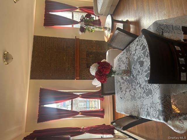 236 Utica Avenue, Unit 2F Brooklyn, NY 11213 - Photo 2 of 8 Dining space with wood finished floors, a brick fireplace, and a baseboard radiator
