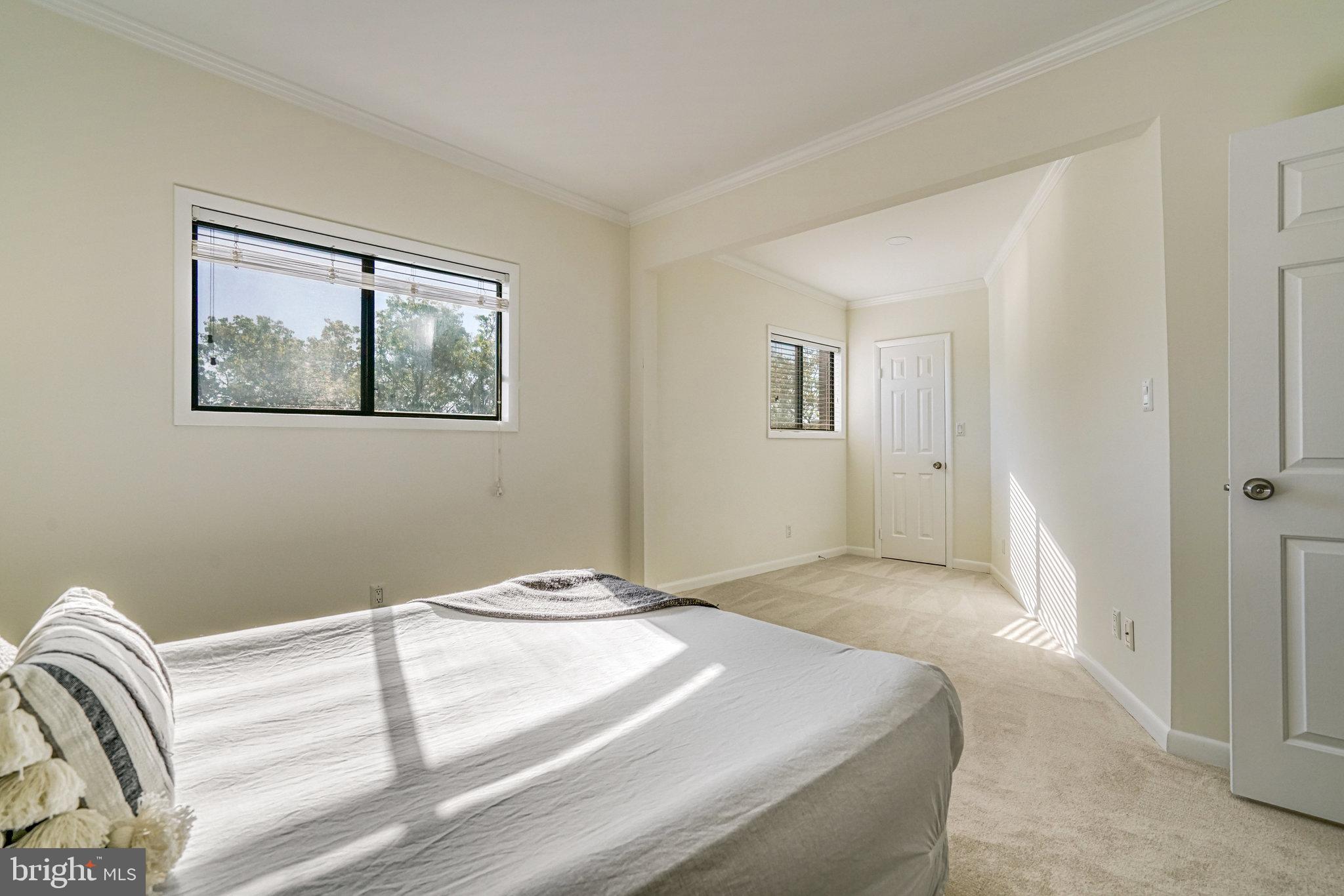 208 Skyhill Road, Unit 10 Alexandria, VA 22314 - Photo 14 of 26 a bedroom with a bed and a painting on the wall