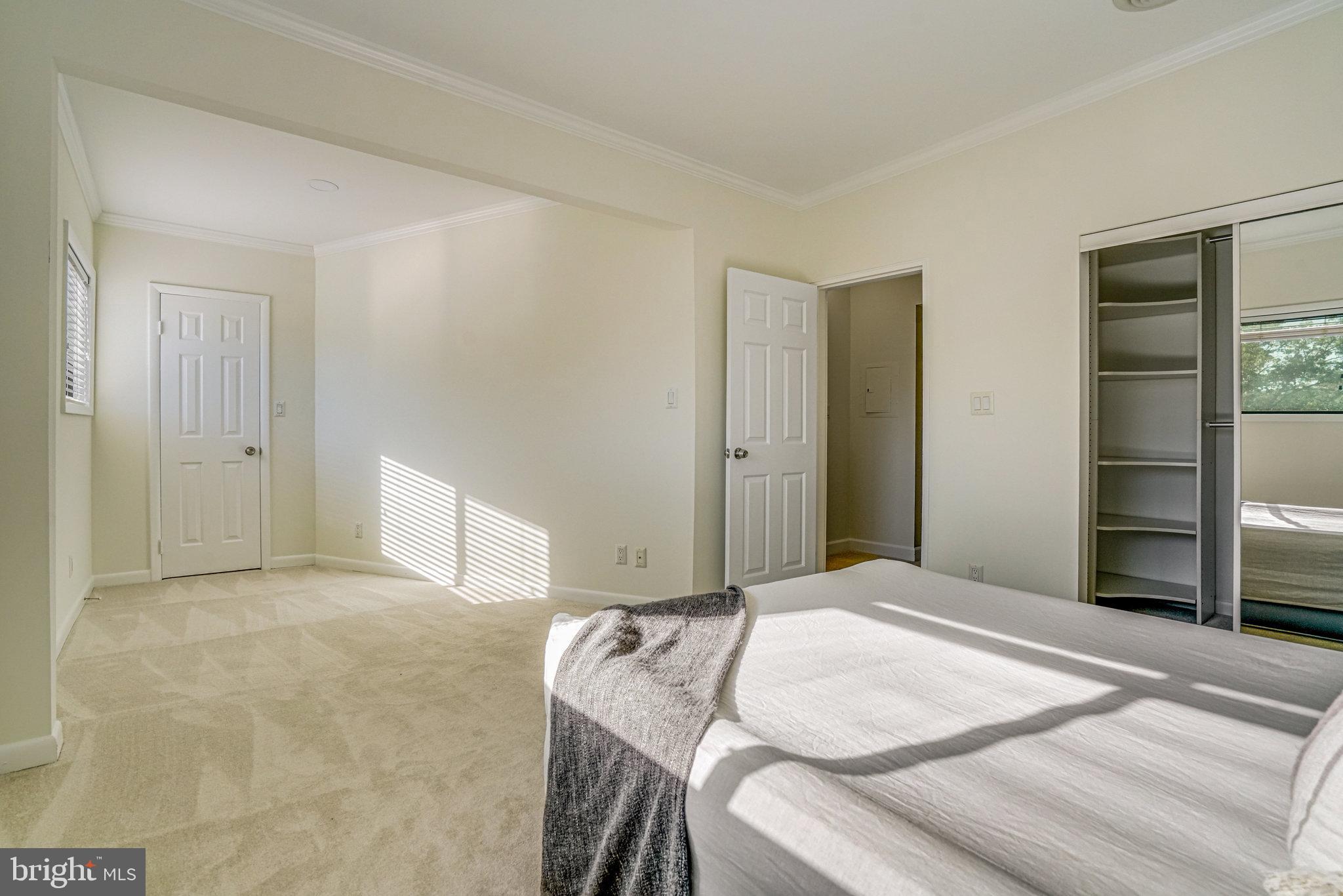 208 Skyhill Road, Unit 10 Alexandria, VA 22314 - Photo 15 of 26 a bedroom with a bed and cabinets