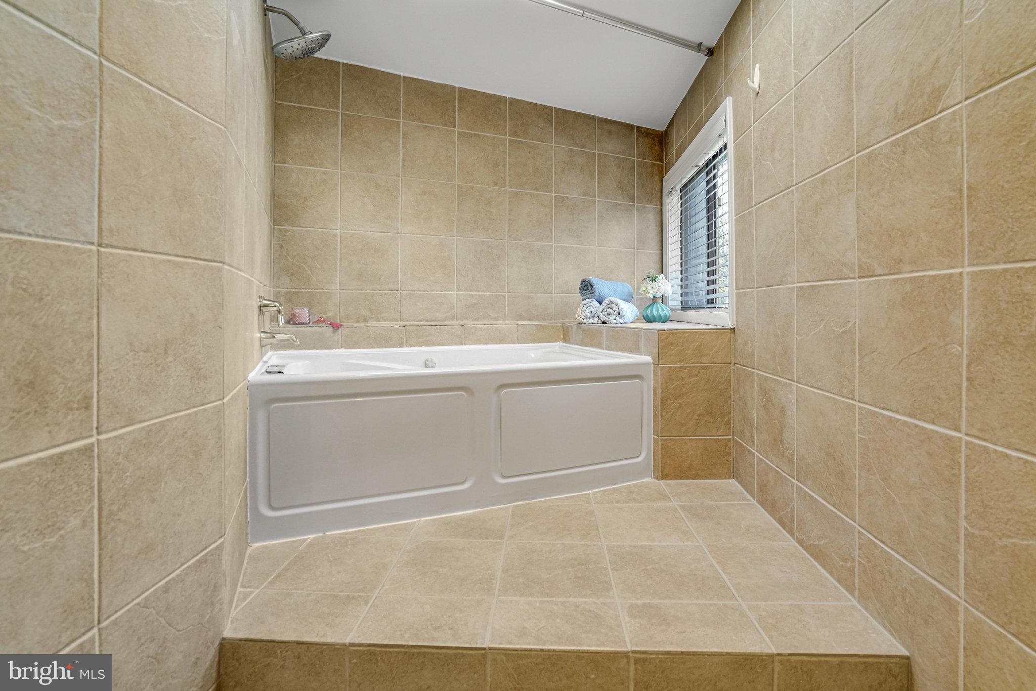 208 Skyhill Road, Unit 10 Alexandria, VA 22314 - Photo 17 of 26 a bathroom with a sink toilet and shower
