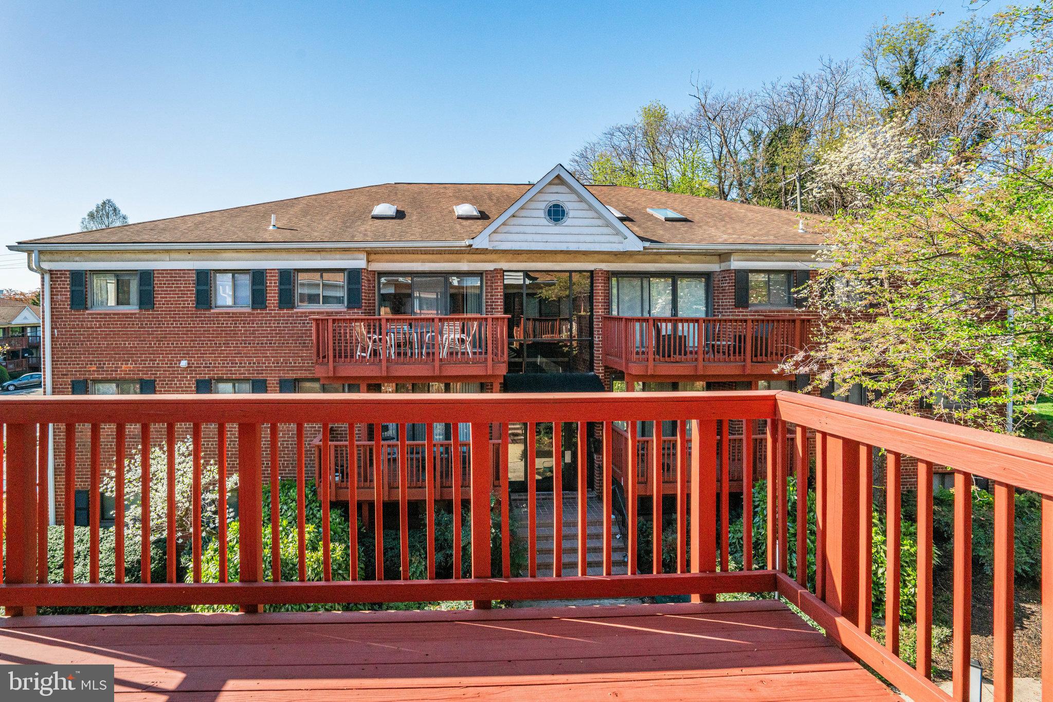 208 Skyhill Road, Unit 10 Alexandria, VA 22314 - Photo 21 of 26 a front view of a house with a garden