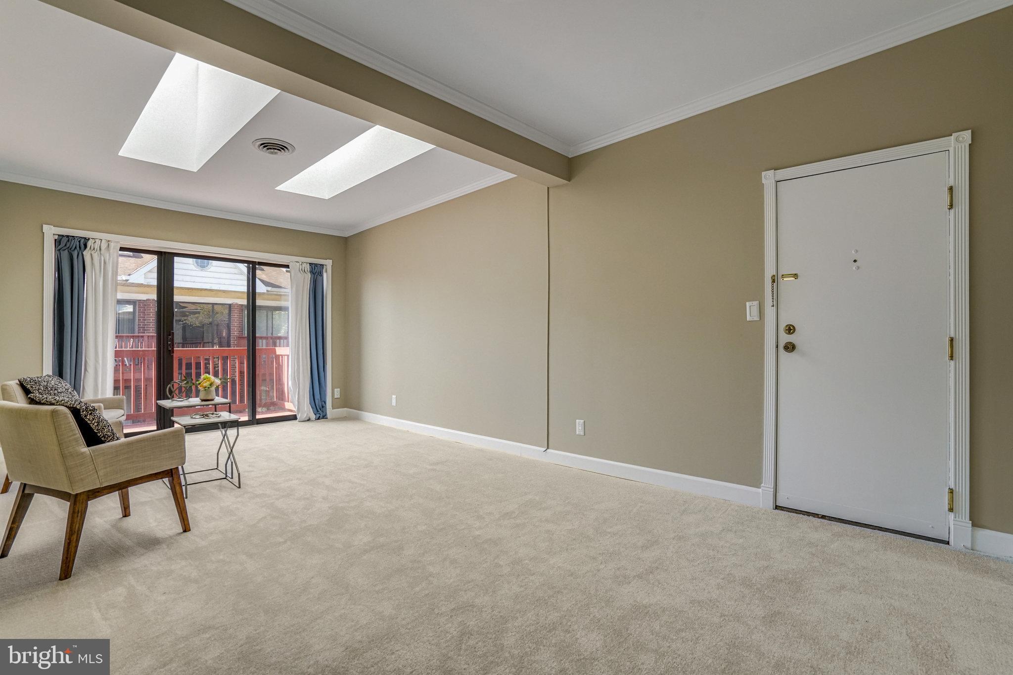 208 Skyhill Road, Unit 10 Alexandria, VA 22314 - Photo 3 of 26 a view of an empty room with wooden floor and a window