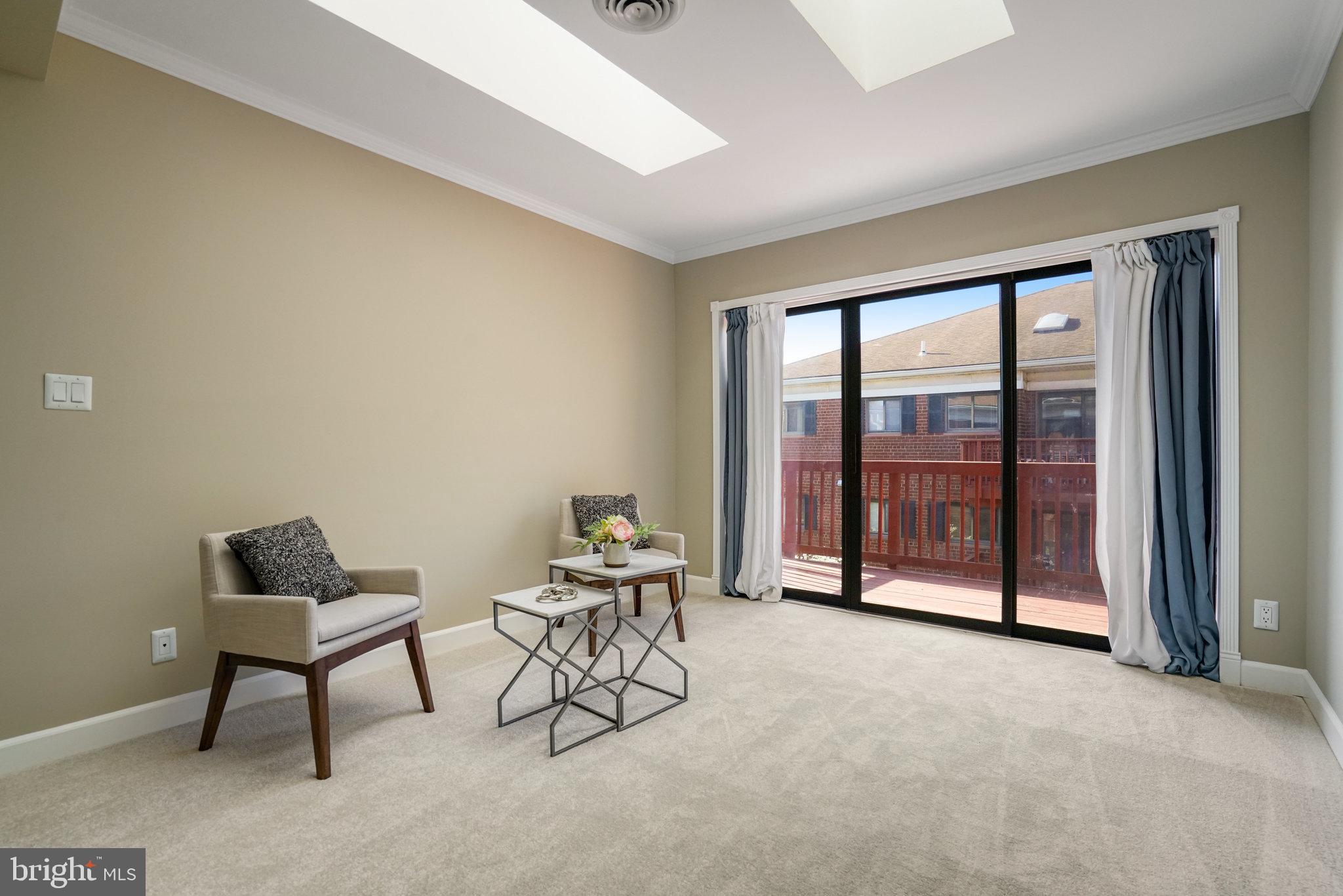 208 Skyhill Road, Unit 10 Alexandria, VA 22314 - Photo 4 of 26 a living room with furniture and a floor to ceiling window