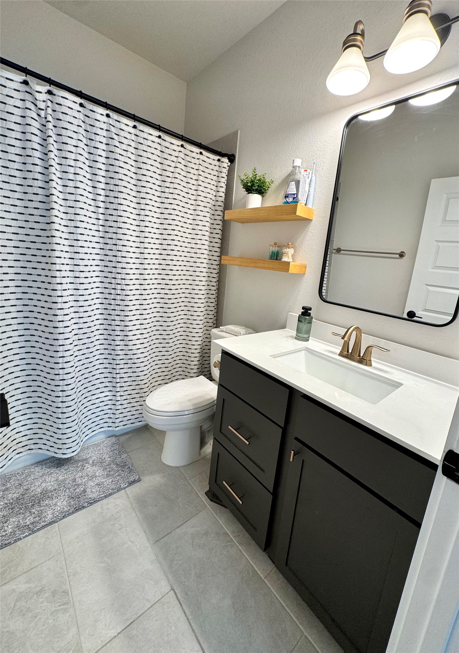 561 Cold Riv Run Kyle, TX 78640 - Photo 17 of 33 a bathroom with a sink vanity mirror and toilet