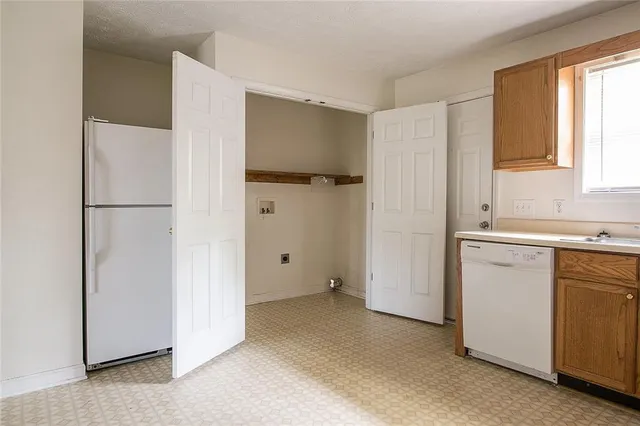 a view of a kitchen with a closet and a window