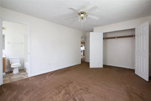 a view of an empty room with a bathroom