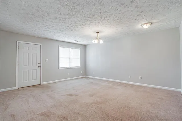 a kitchen with stainless steel appliances granite countertop a refrigerator a sink dishwasher a stove and a refrigerator with wooden cabinets