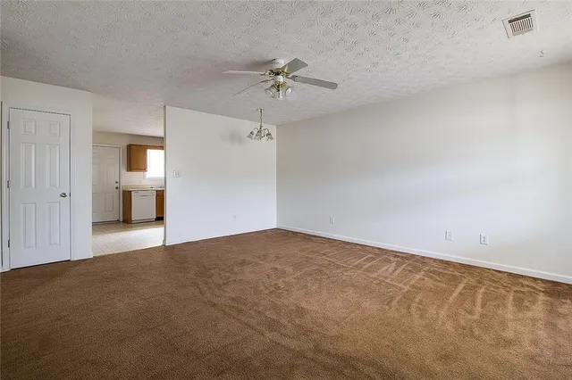 a view of a kitchen with a dishwasher and a refrigerator