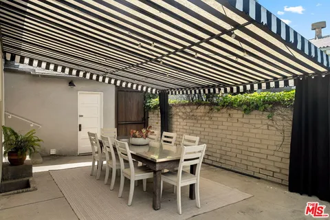 a patio with table and chairs