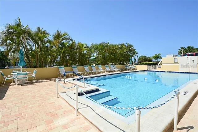 a view of swimming pool with chairs