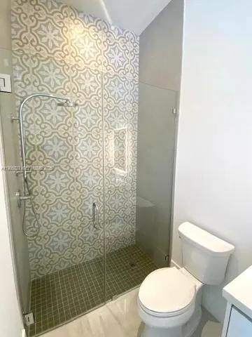 a white toilet sitting next to a shower curtain