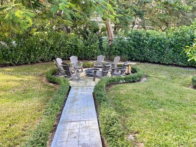 7830 Southwest 117th Street Pinecrest, FL 33156 - Photo 22 of 26 a view of a swimming pool with a patio