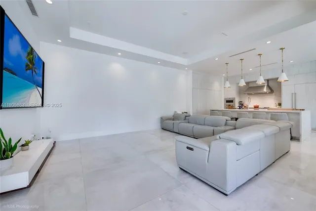 a living room with furniture and kitchen view