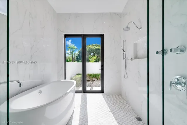 a bathroom with a tub and a shower