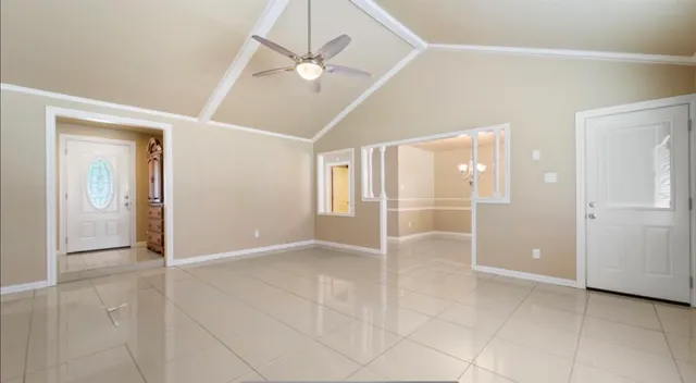 an empty room with fan and entrance