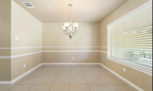 a view of a room with window and chandelier