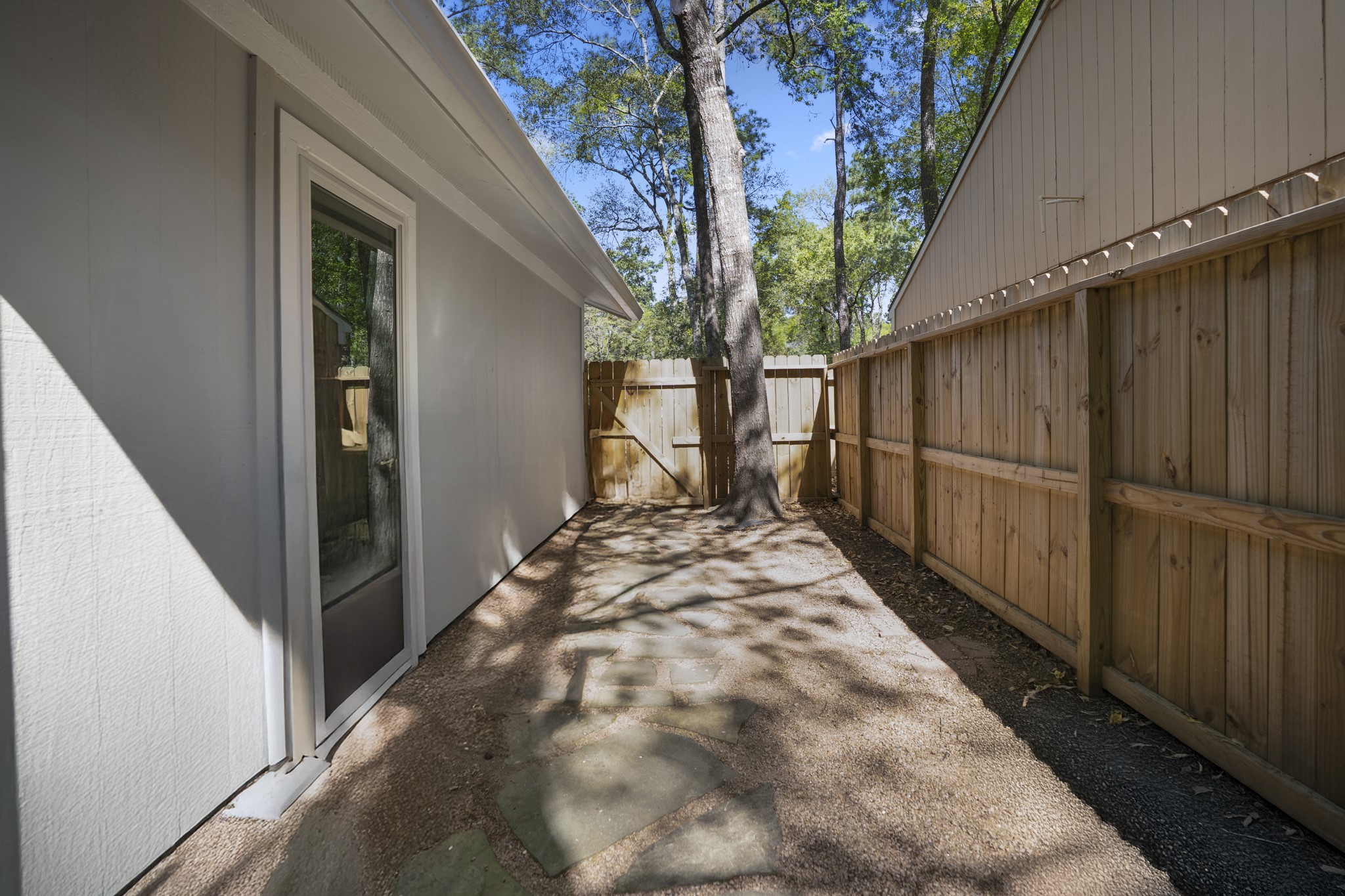 12224 Gun Oak Place Spring, TX 77380 - Photo 31 of 37 Patio Area Nestled Beneath Mature Trees, Creating the Perfect Setting for Outdoor Gatherings
