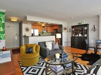 a living room with furniture and a dining table