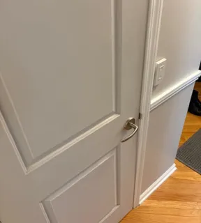 a view of a room with wooden floor and cabinet