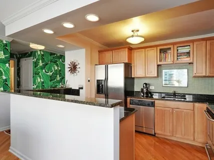 a kitchen with granite countertop a center island appliances and a window