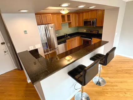 a kitchen with stainless steel appliances refrigerator stove microwave and cabinets