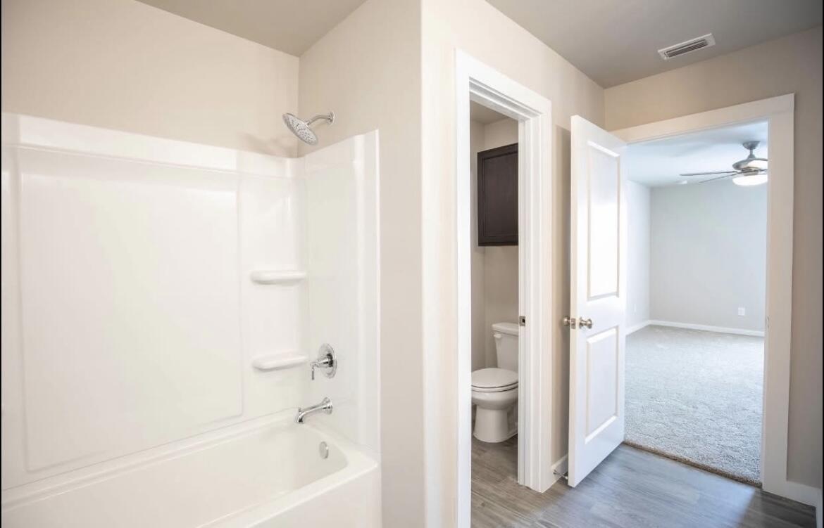 2410 144th Street, Unit 12 Lubbock, TX 79423 - Photo 10 of 13 a bathroom with a bathtub and a shower